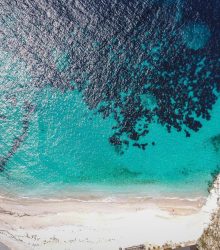 Stunning aerial shot of Himarë's coastline revealing turquoise waters and sandy shores.