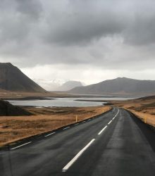 Explore the breathtaking Icelandic countryside with this stunning mountain road view, perfect for nature lovers.