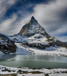 Scenic winter view of the Matterhorn mountain with a lake, perfect for adventure and travel imagery.